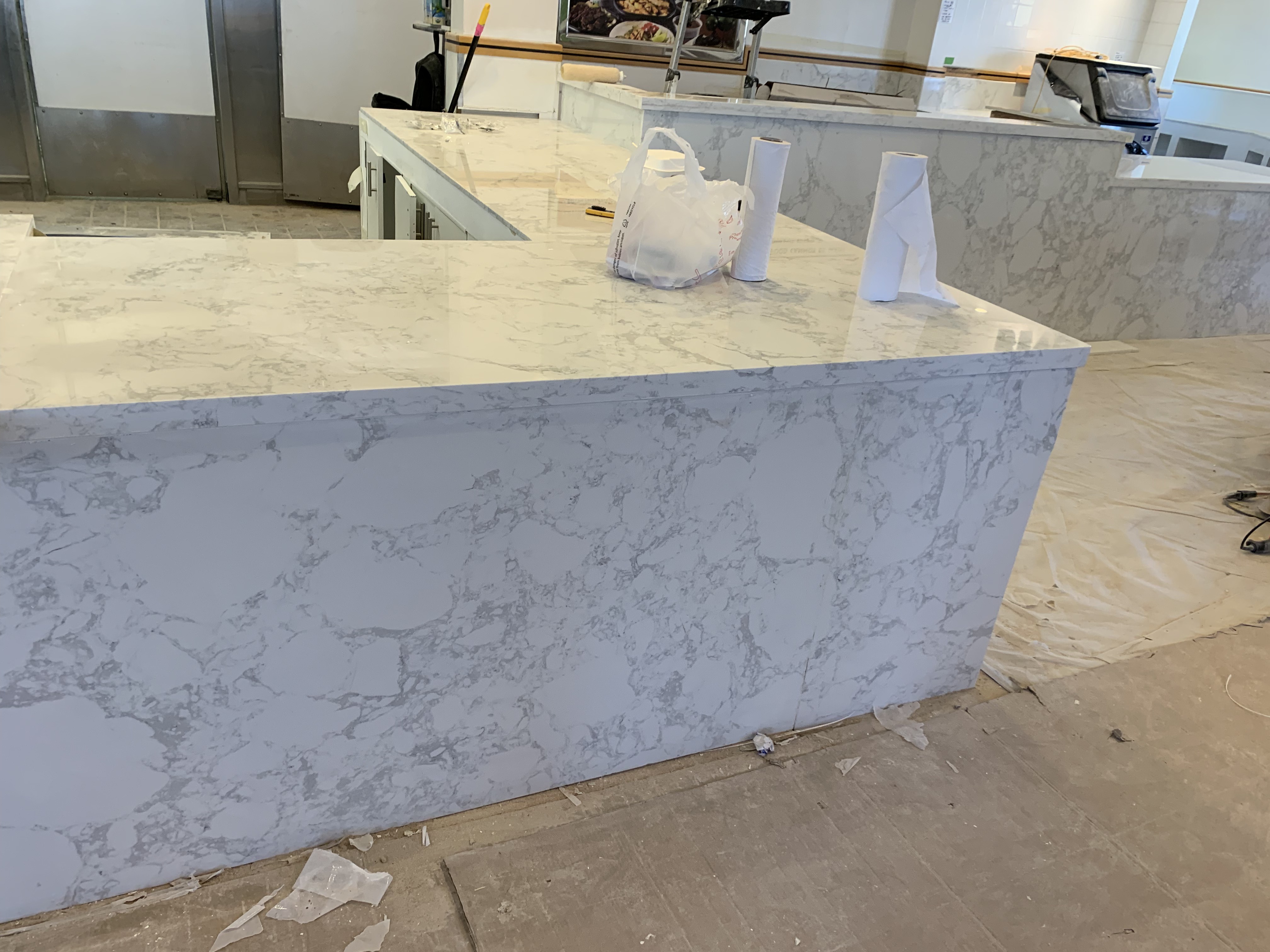 Quartz counter with a waterfall end panel on a commercial service counter