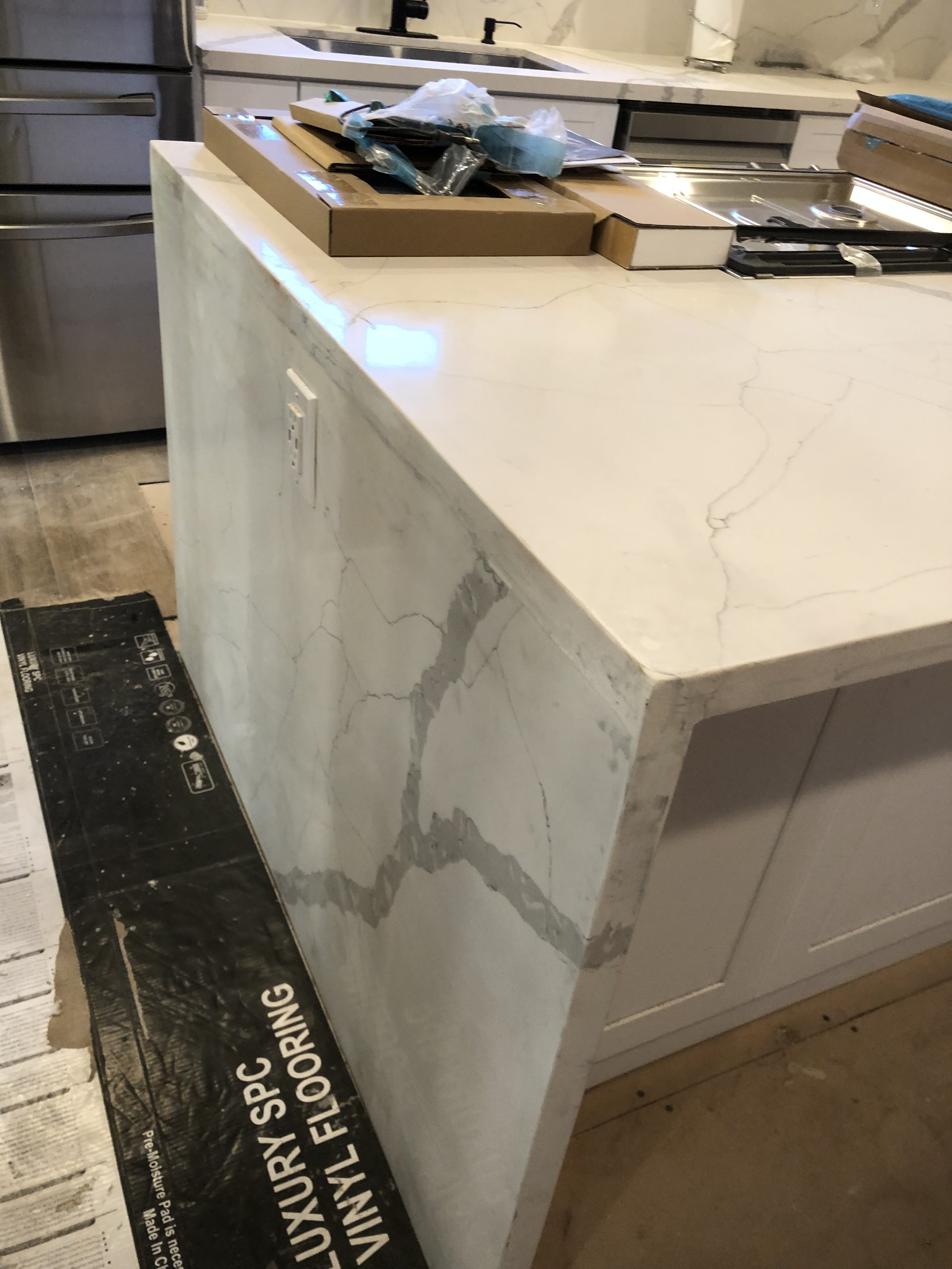 Waterfall quartz island edge during installation