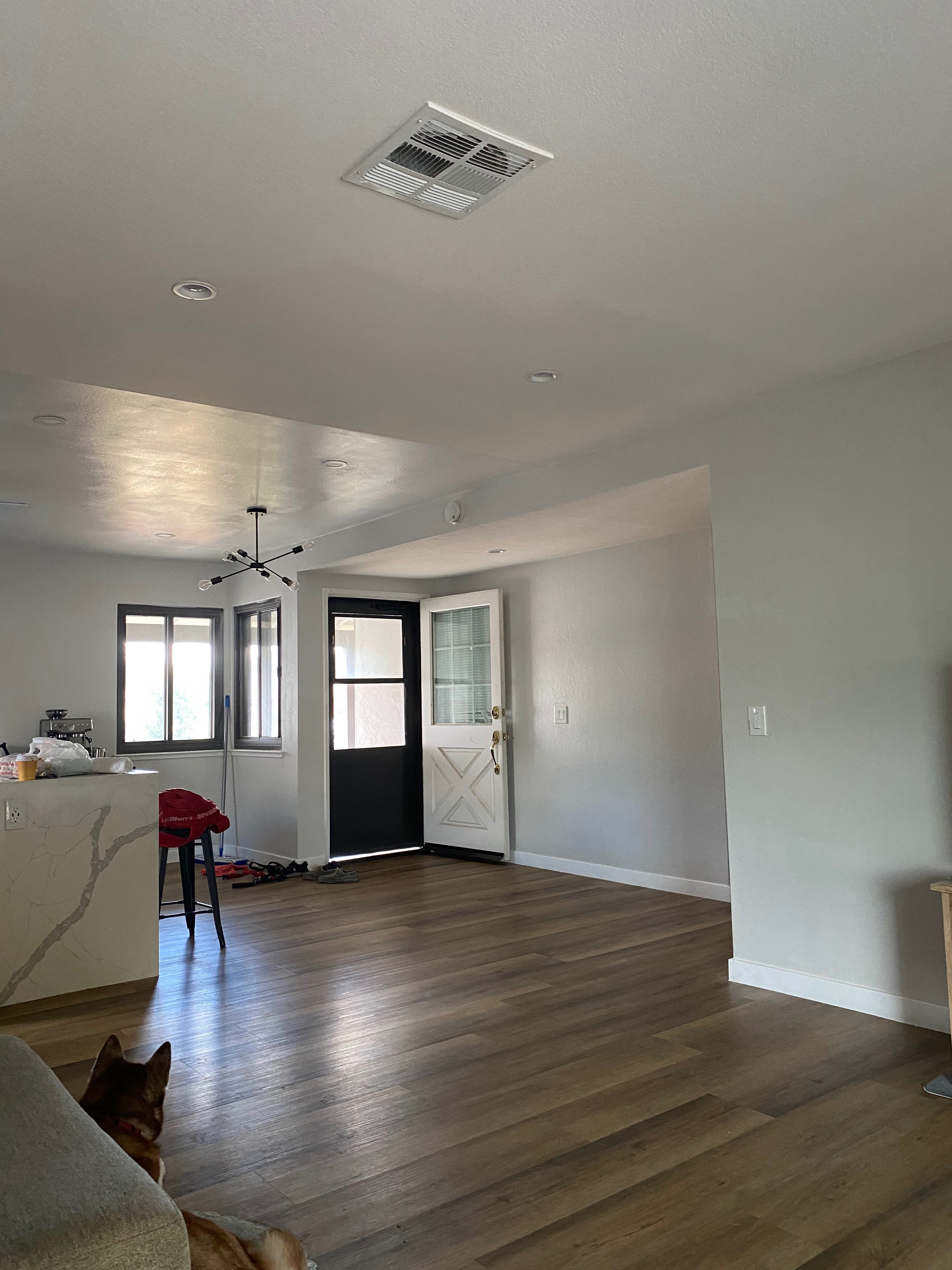 Finished living area with vinyl plank flooring and recessed lights